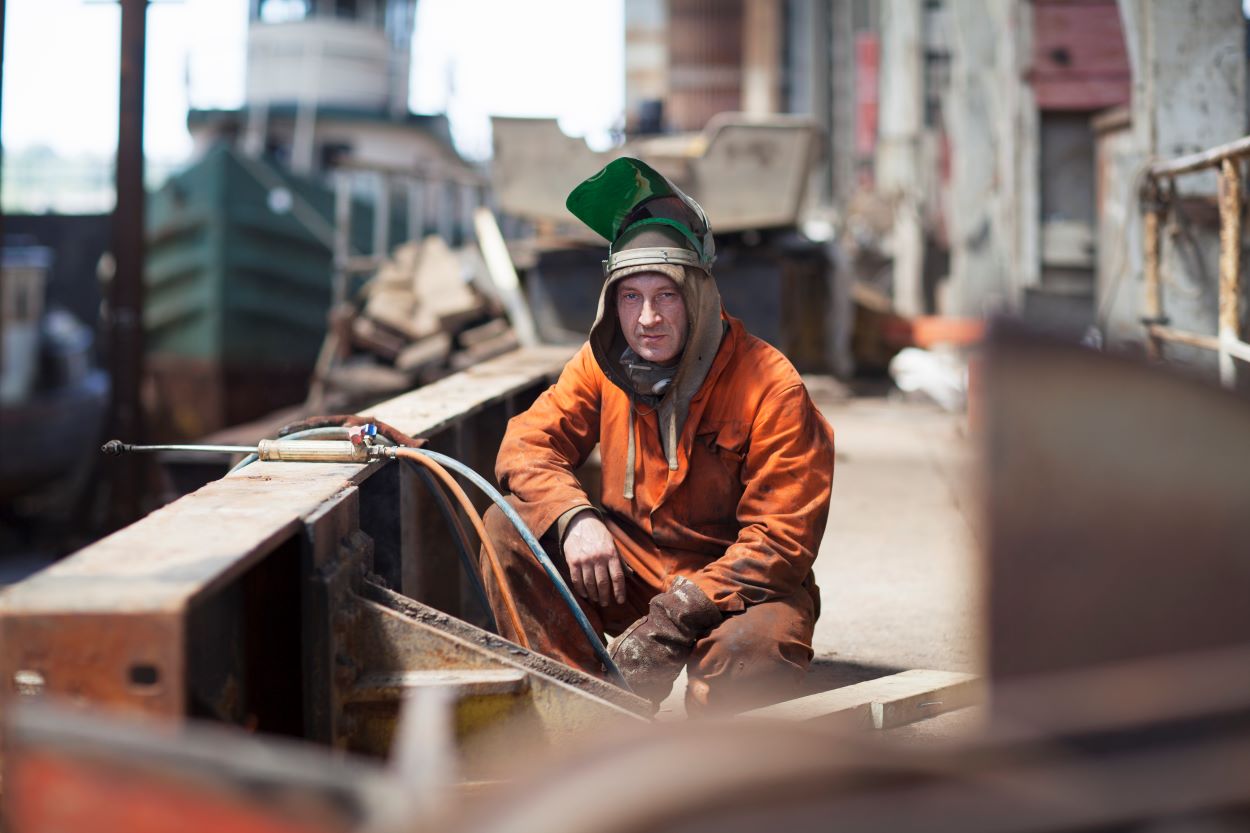 a welder from CTR Group a shipyard staffing agency takes a break from welding in shipyard. 