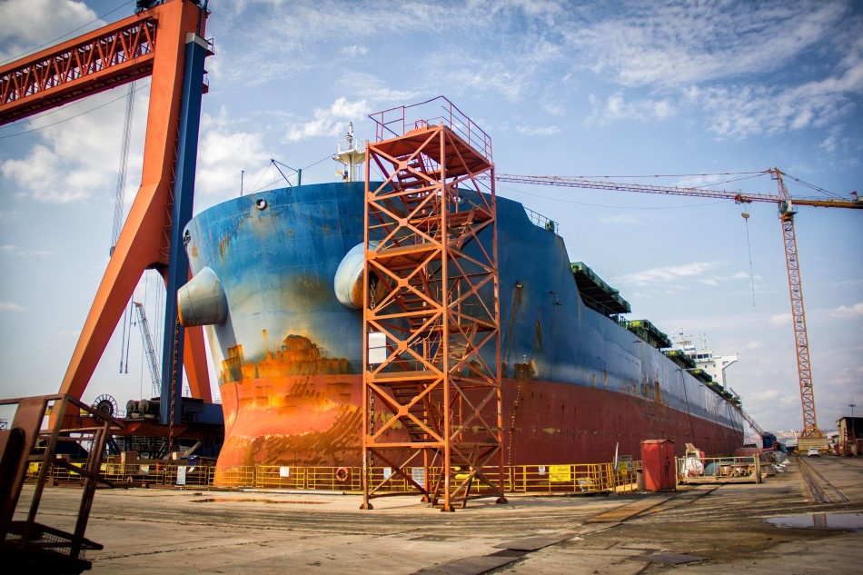 CTR staffing shipyard jobs. a large tanker cargo ship being renovated and painted in the shipyard dry dock. 